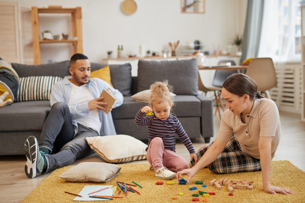 interracial family playing at home with toddler